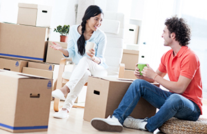 Couple sitting among moving boxes