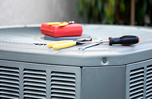 Tools on top of a home air conditioner