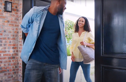 Image of couple entering home