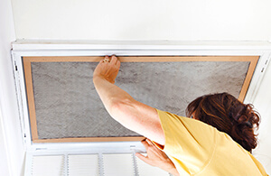 Person changing HVAC filter