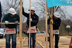 Volunteers holding home frame