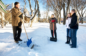 Family shoveling snow