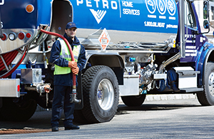 Petro service tech in front of oil truck