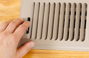 Man adjusting vent