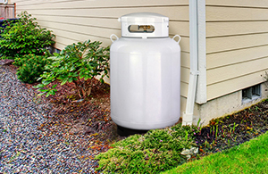 Image of propane canister by side of house
