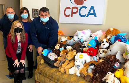 Volunteers in front of stuffed animals