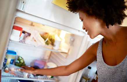 Woman getting eggs from refrigerator